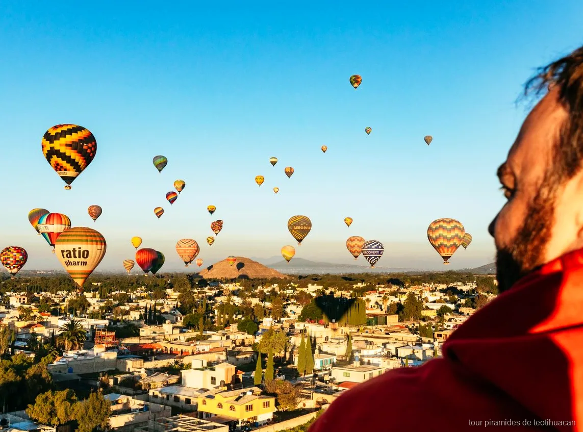 Hot air balloon flying over the Teotihuacan pyramids at sunrise